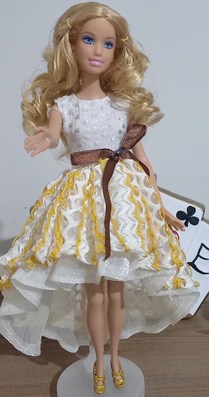 Fashion Girl Doll features long blonde curly hair and blue eyes.