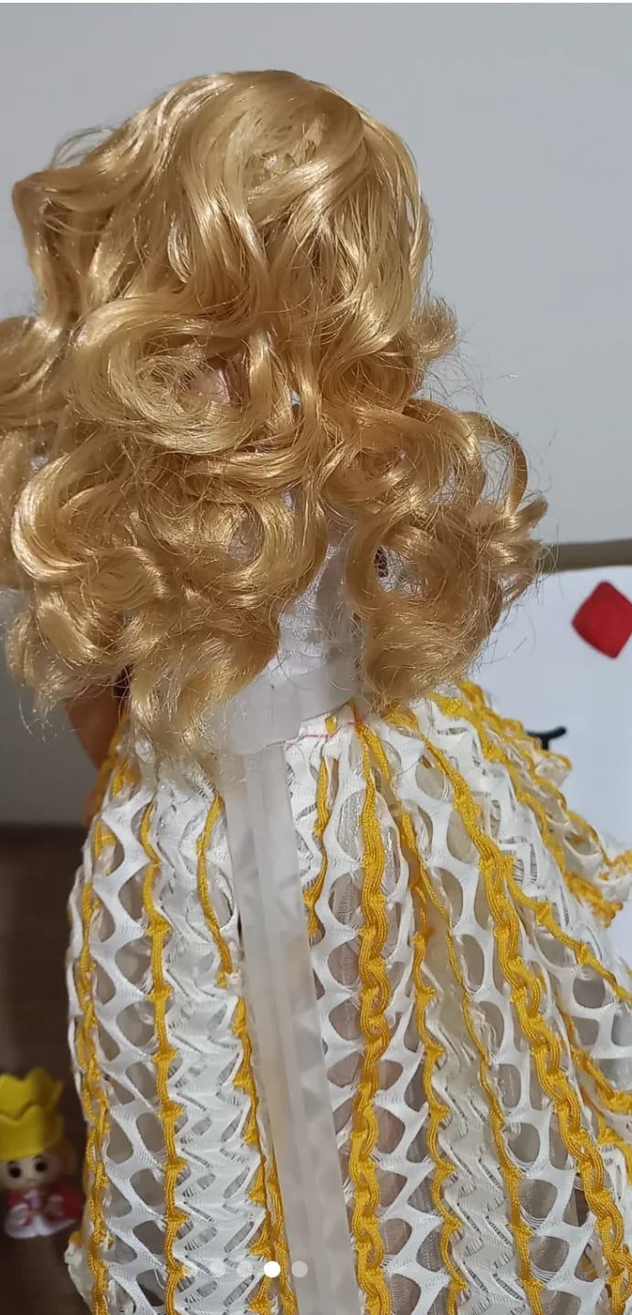 Fashion Girl Doll features long blonde curly hair and blue eyes.