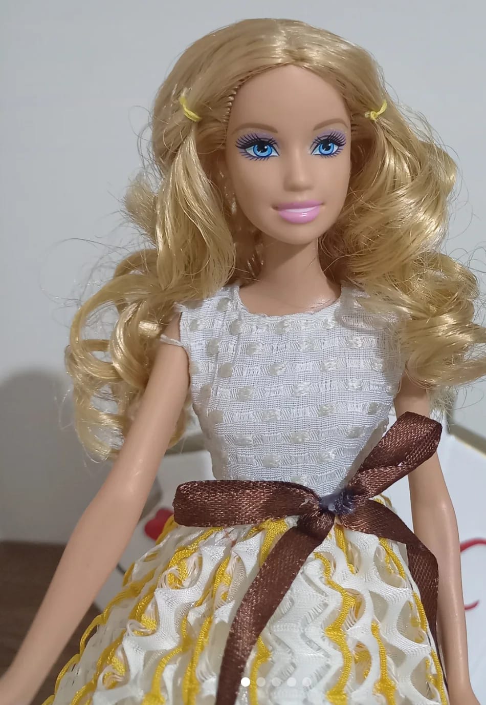 Fashion Girl Doll features long blonde curly hair and blue eyes.